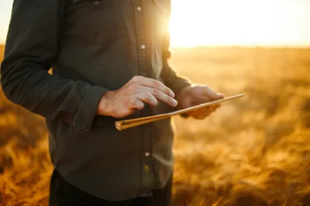 amazing-photo-farmer-checking-wheat-field-progress-holding-tablet-using-internet