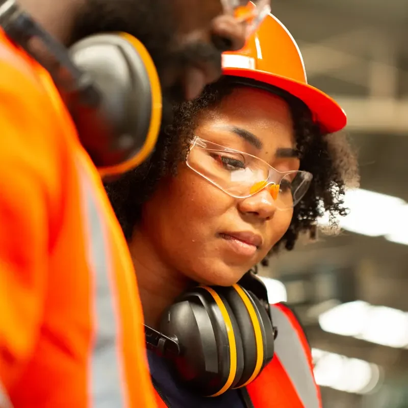 close-up-african-engineer-site-working-with-her-team-production-line-supervisor-look-check-job-factory-workplace-operation-staff-with-safety-uniform