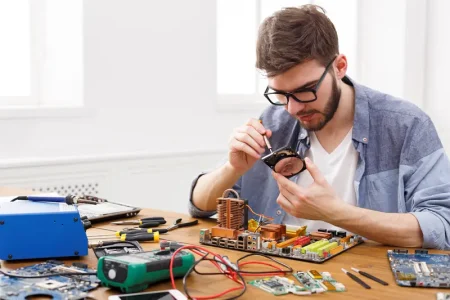 engineer-holding-winchester-disk-hands-repairman-fixing-broken-computer-hard-disk-electronic-repair-shop-copy-space