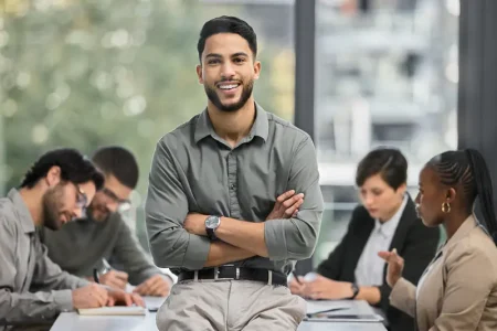 how-quickly-life-can-turn-around-portrait-young-businessman-office-sitting-front-his-colleagues-having-meeting-background