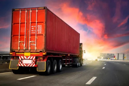 image-motion-blur-truck-highway-road-with-red-container-transportation-concept-import-export-logistic-industrial-transporting-land-transport-asphalt-expressway-with-sunrise-sky